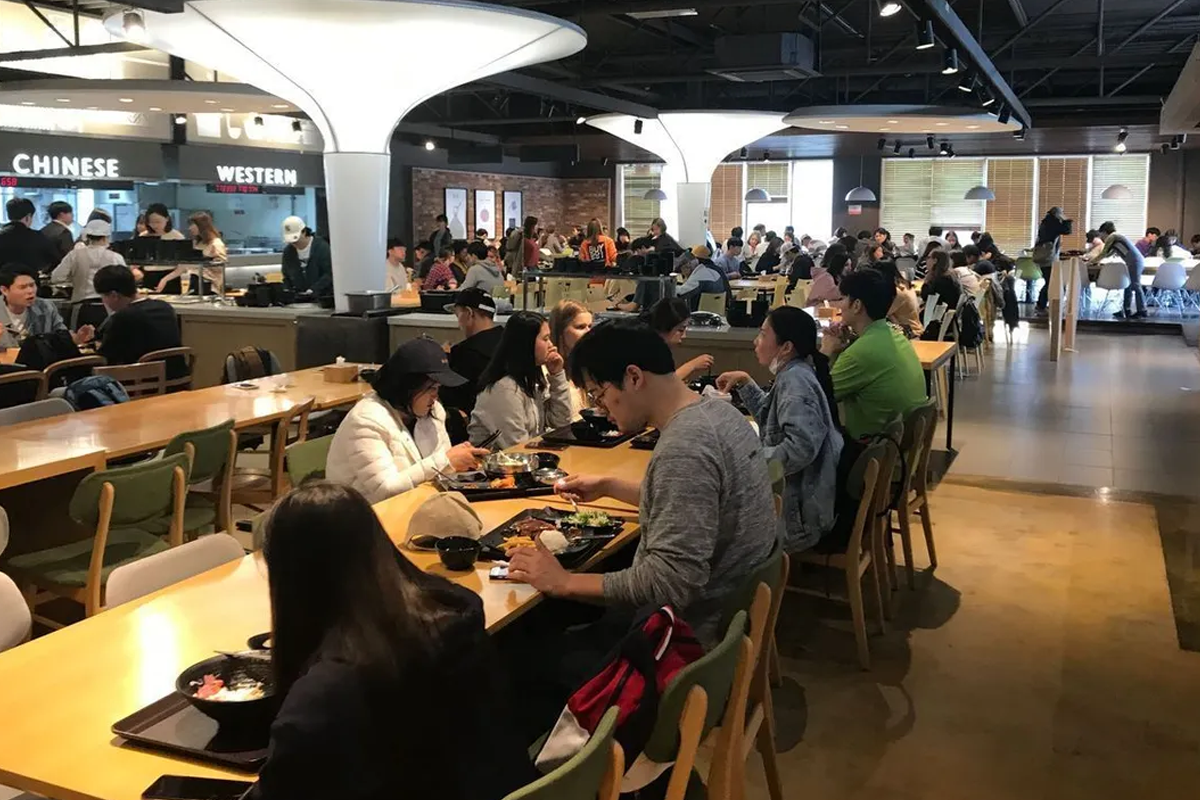 韓國大學餐廳內繁忙的午餐時間，滿滿的學生享受校園餐飲服務。