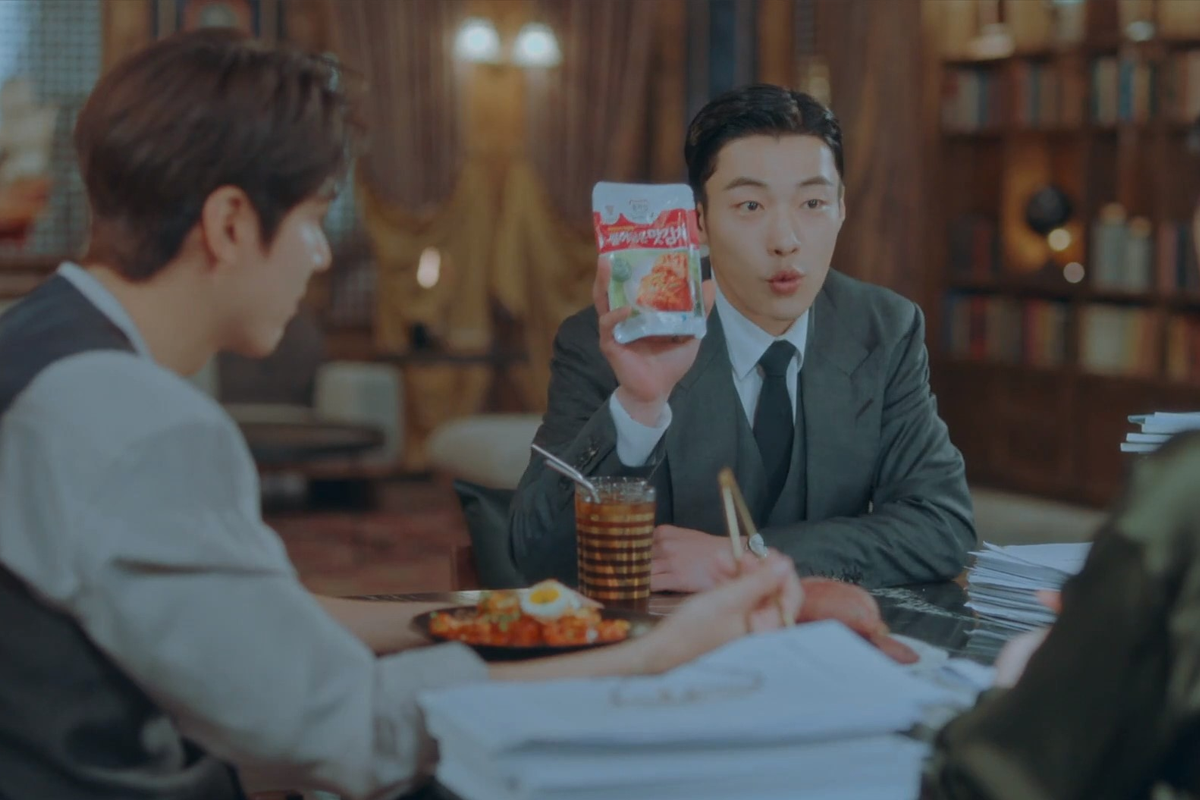 scene from the king: eternal monarch with actor woo do-hwan holding up jongga job kimchi
