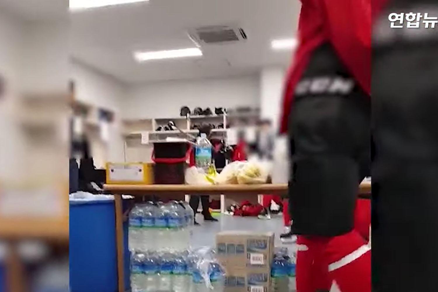 ชายคนหนึ่งกำลังตีเด็กนักเรียนที่สวมชุดฮอกกี้