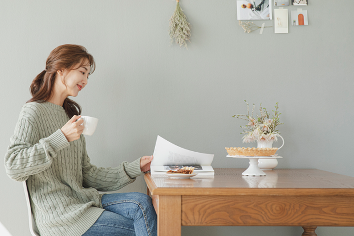 girl sitting at a desk drinking 