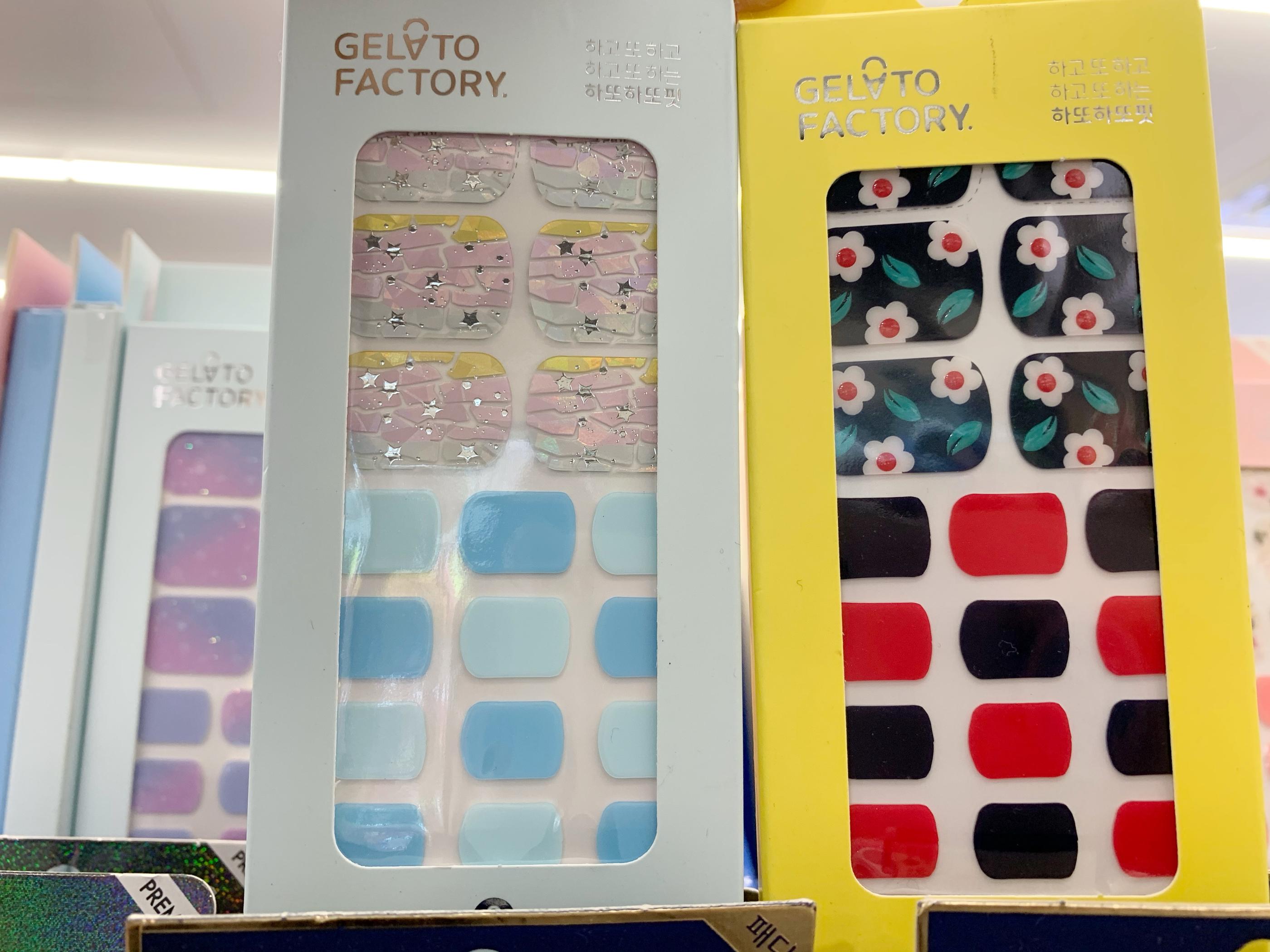 gelato factory nail stickers, one with pink, and yellow crackled pattern with tones of blue, another with black and red tones and flower patterns at olive young