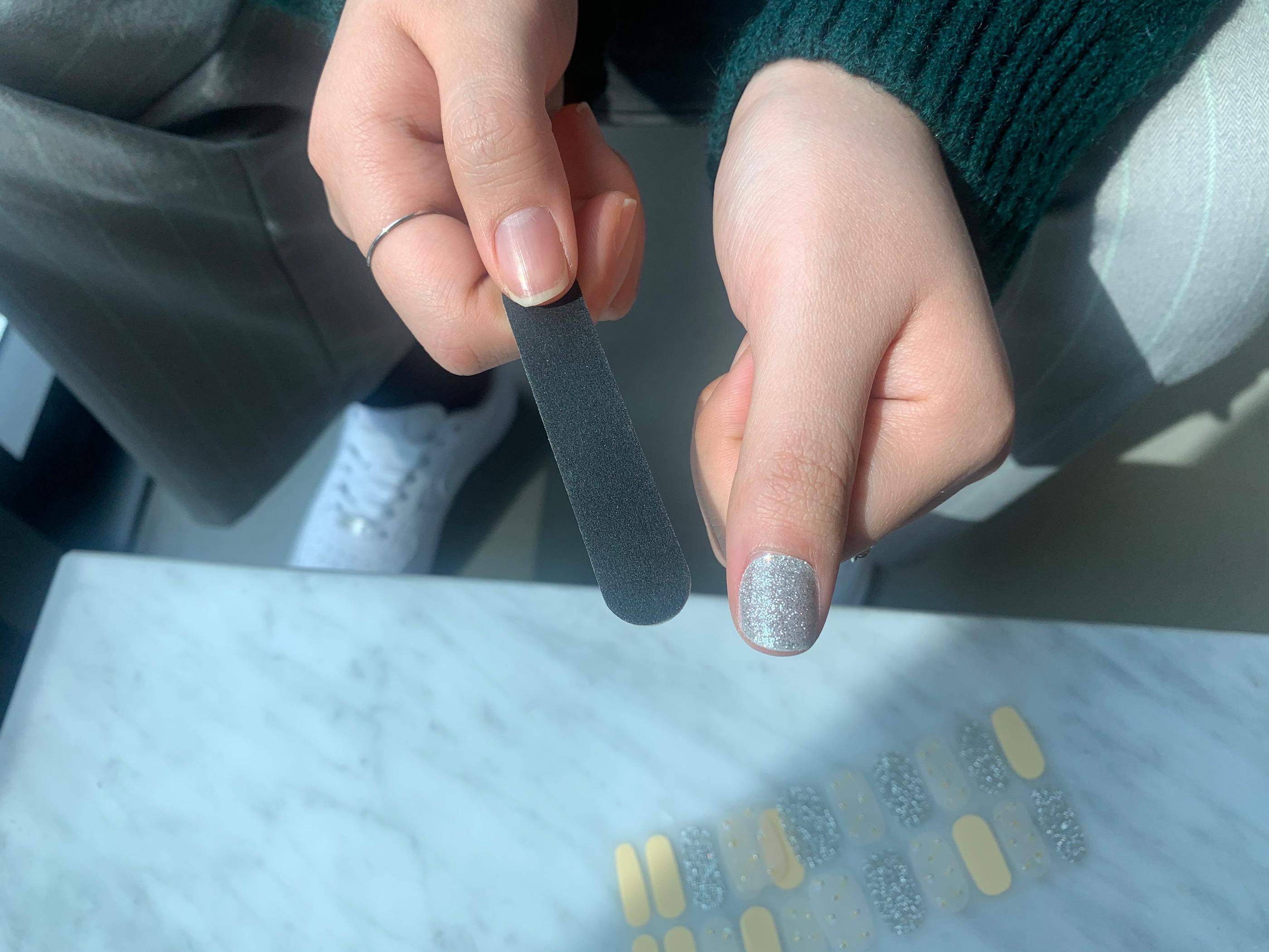 gelato factory silver and glitter nail sticker on thumb after filing off excess sticker