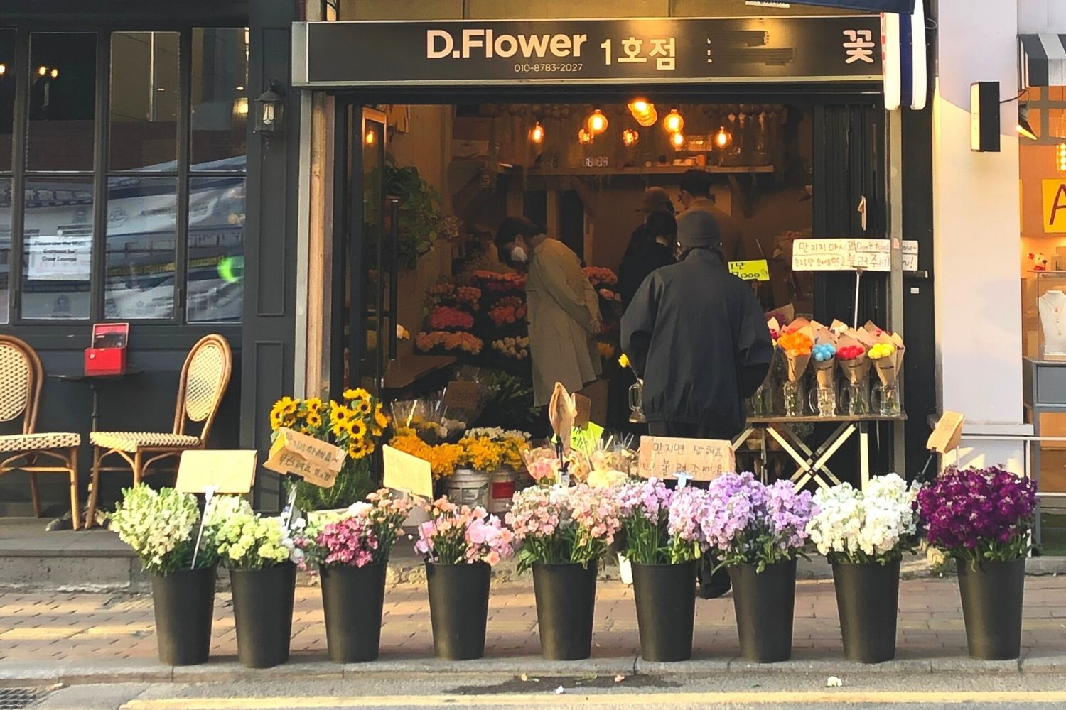 D.flower exterior flowers in buckets lined up outside