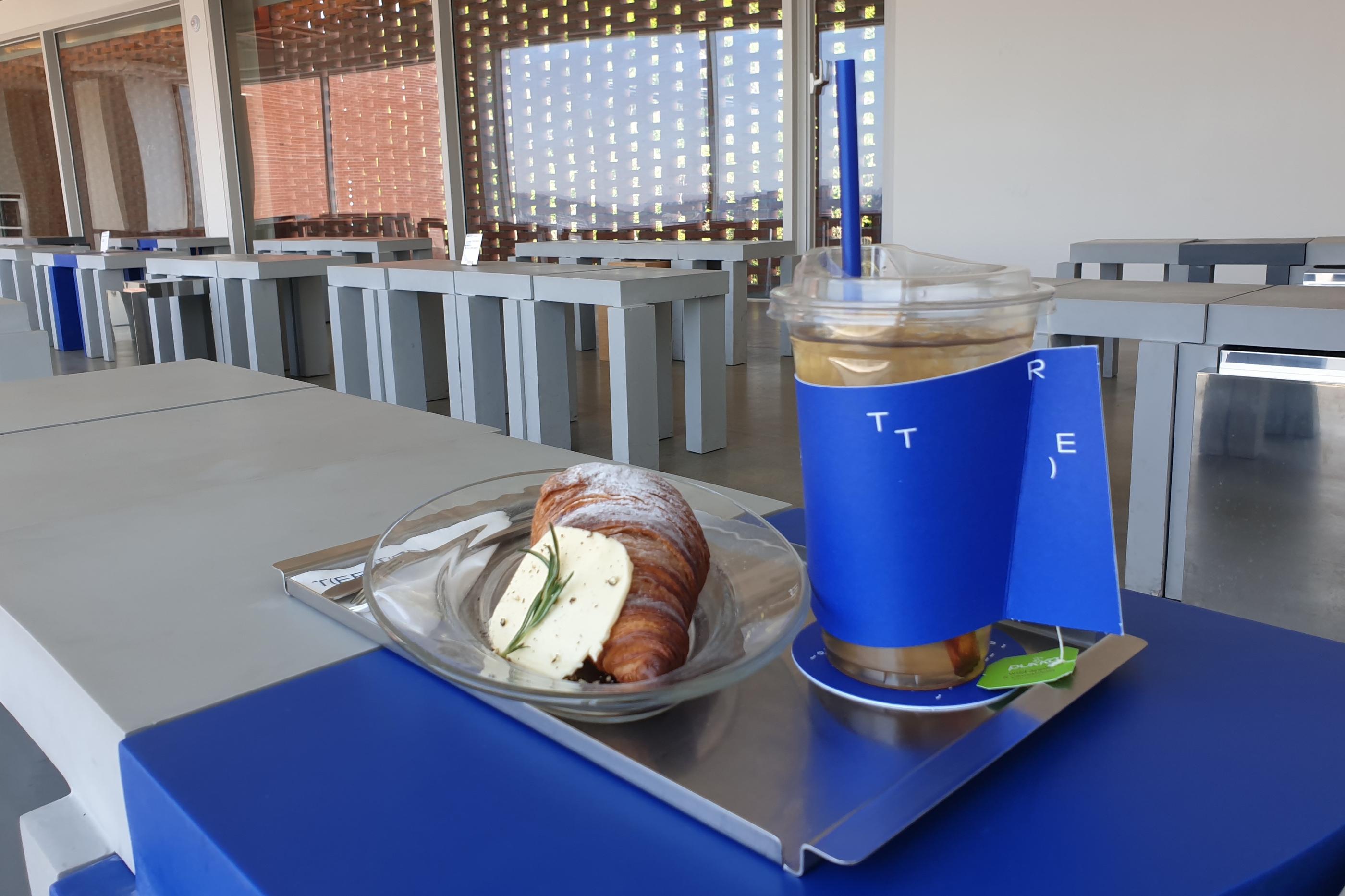 T(ER)T(RE) apple cinnamon drink and butter croissant drink on tray outside