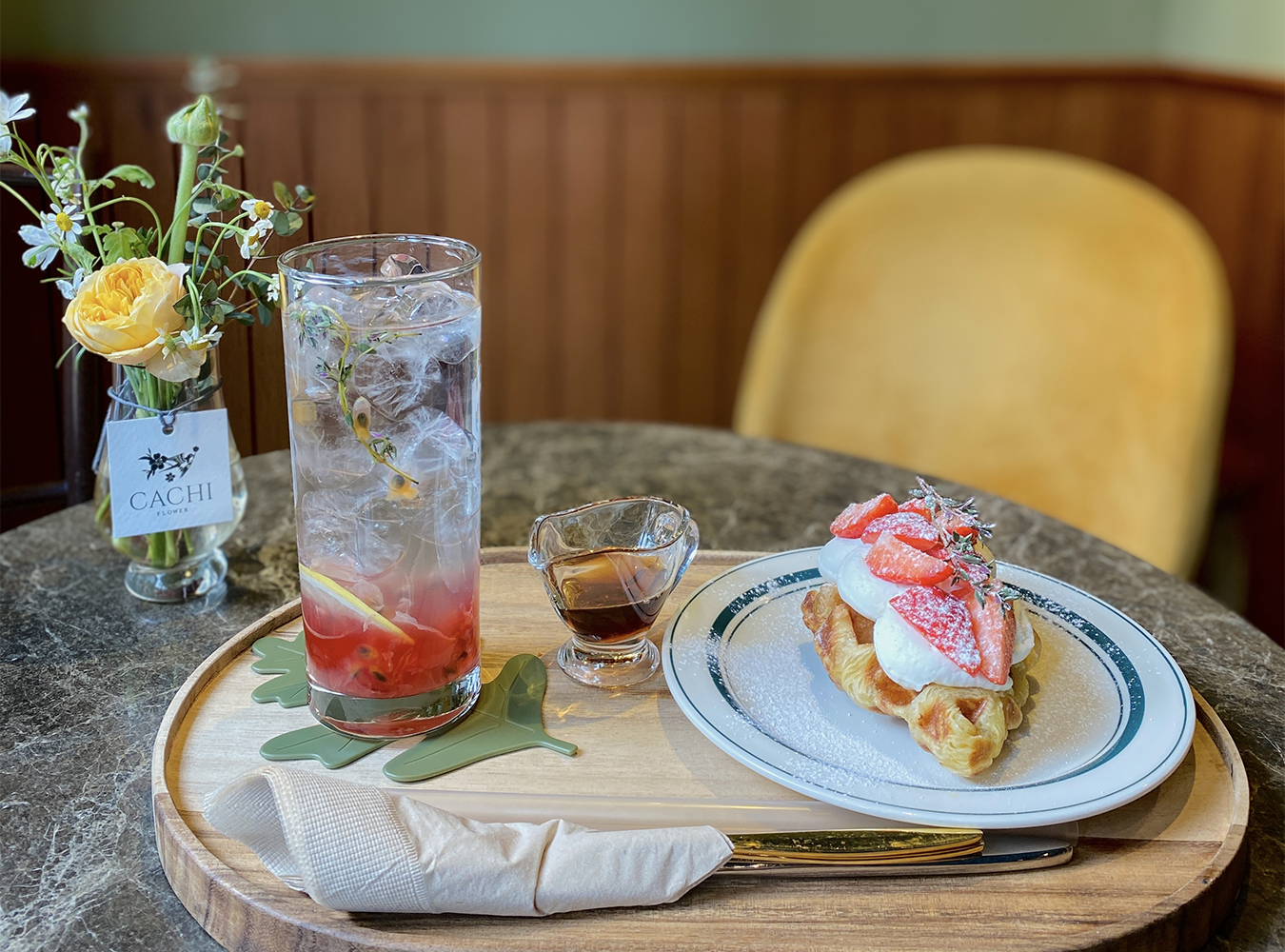 Iced tea, croffle with cheese cream and strawberries on top, served with maple syrup in gangnam
