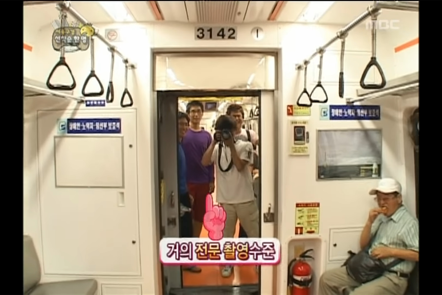 koreans in subway taking a photo with a camera