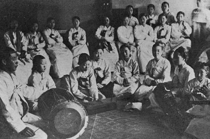 black and white image of group of korean gisaeng learning music at pyongyang gisaeng school