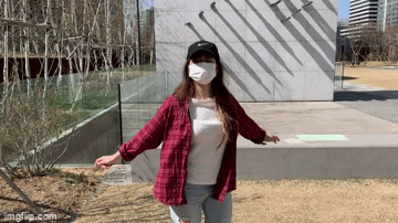 girl spinning in red plaid shirt