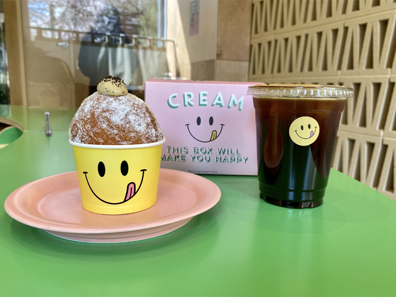 cafe knotted box of donuts, one donut for here and iced americano