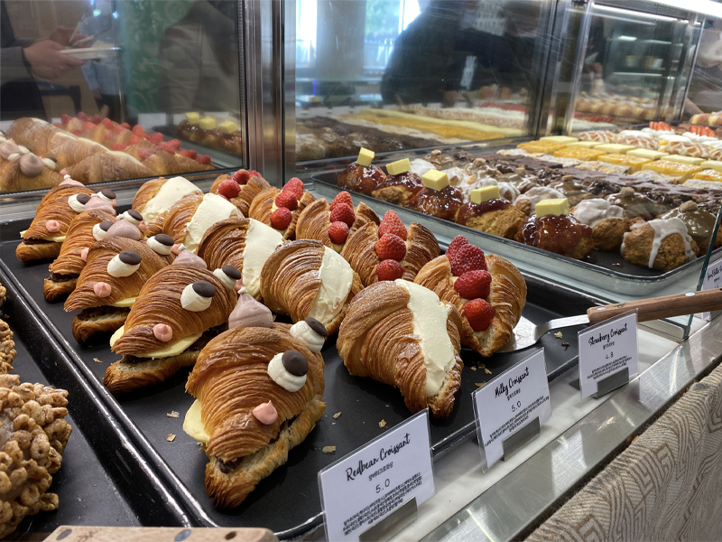 cafe knotted pastries (croissants with different cream and toppings) on display