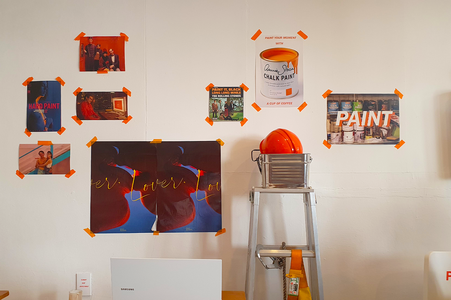 posters on white wall at paint cafe