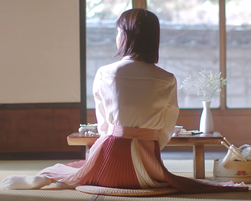 Korean girl in long pink skirt sitting on the floor