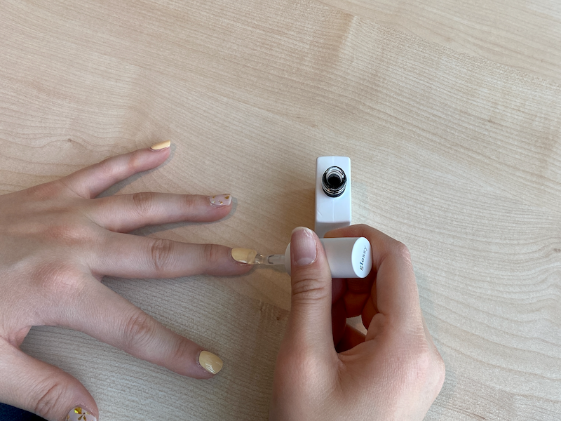 Applying the top gel on nails after curing the self gel stickers