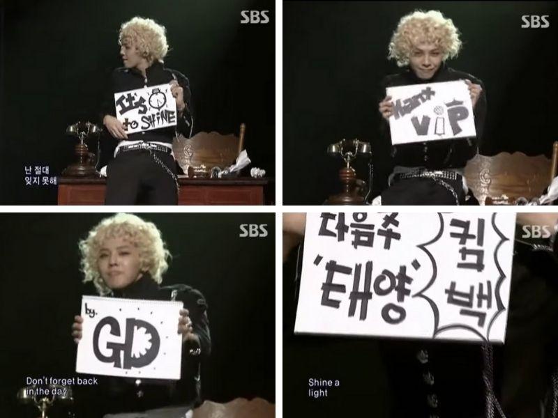 Kpop idol performing on SBS stage with handwritten signs showing messages 'It's Time to Shine,' 'by GD,' 'VIP,' and 'Taeyang Comeback Next Week', representing a fun and innovative trend in Kpop performances.