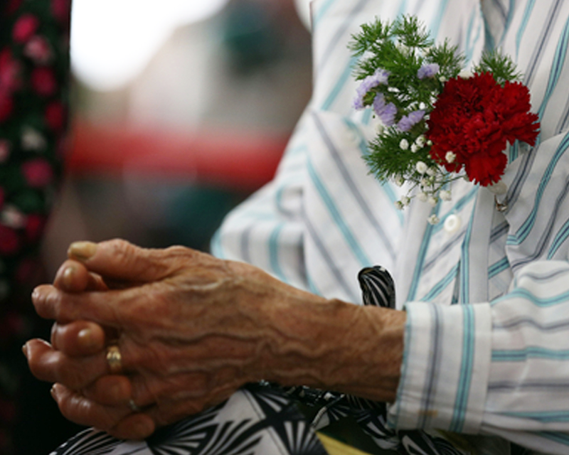 Elderly mother with a carnation on her chest