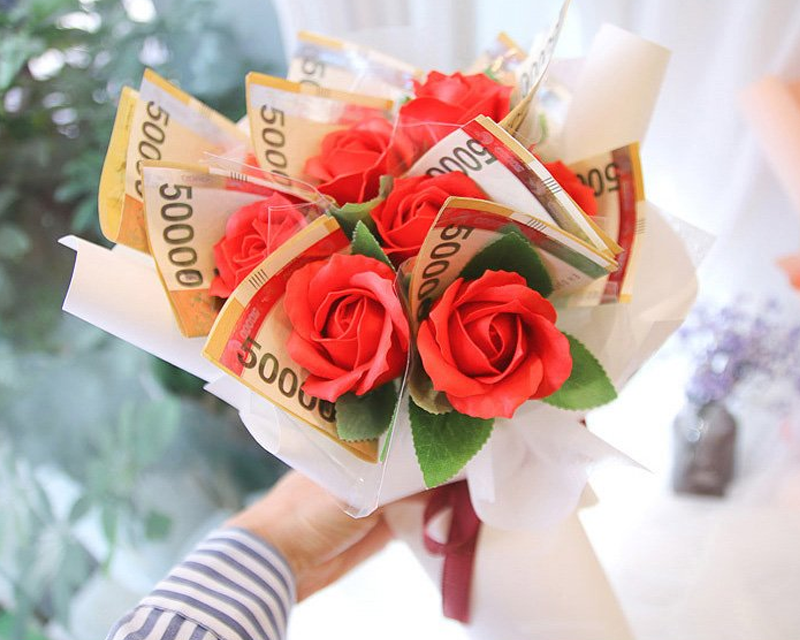 Un ramo de dinero completo con flores