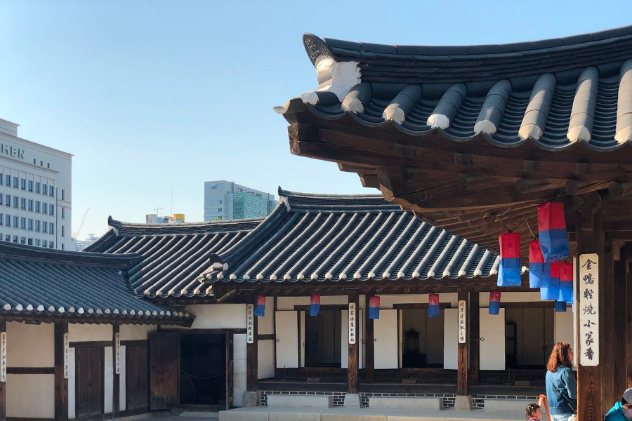 Colorful traditional Korean decorations outside a hanok in Namsan Hanok Village, Seoul, creating festivity.