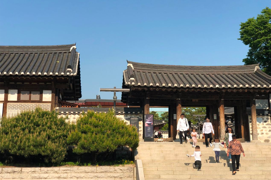 Picturesque traditional entrance and stone steps leading to Hanok houses at Namsan Hanok Village.