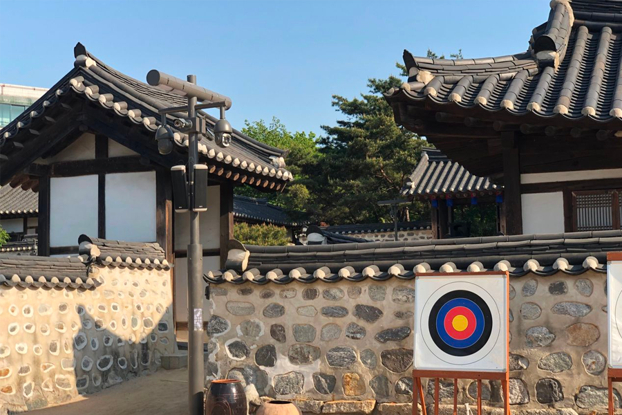 A traditional Korean courtyard in Namsan Hanok Village displaying outdoor kitchen essentials.