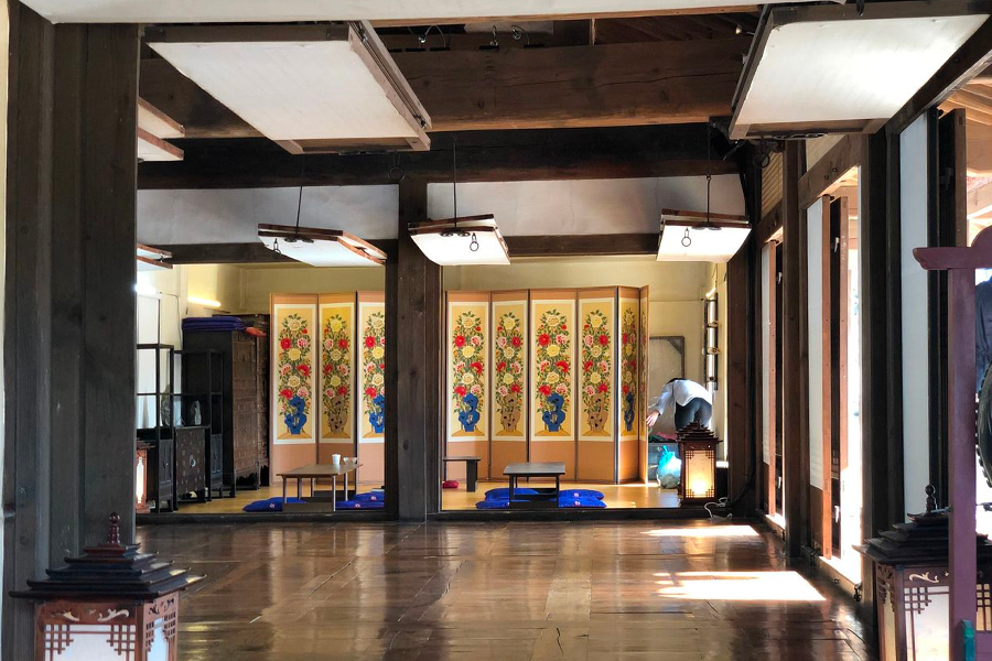 Interior of Namsan Hanok Village room decorated with wooden panels portraying traditional Korean aesthetics.