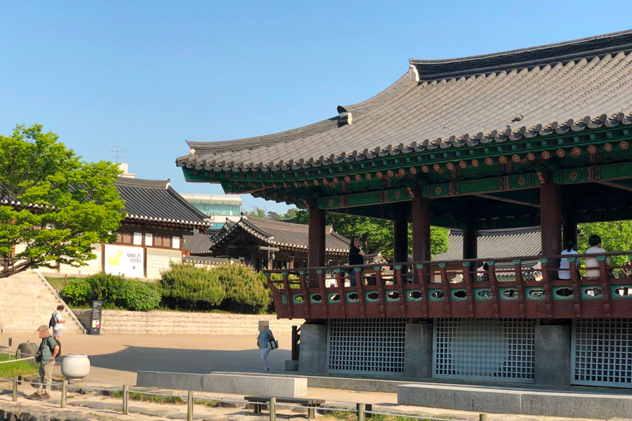 Traditional Korean stone wall and architecture seen at Namsan Hanok Village entrance, Seoul.