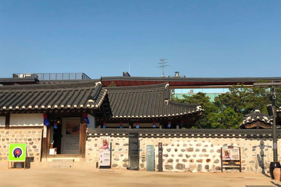 Traditional Korean houses with stone walls and tiled roofs at Namsan Hanok Village, Seoul.