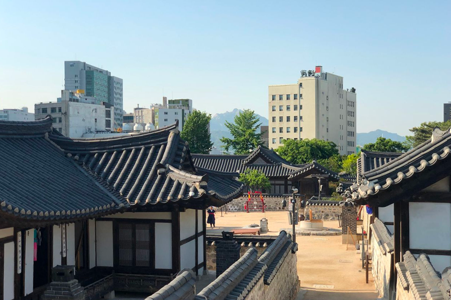 Namsan Hanok Village's open courtyard designed with wood and stone, instantly taking you back in time.