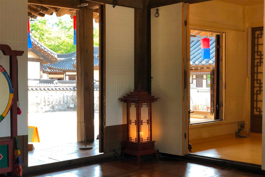 Interior look through the courtyard doors at Namsan Hanok Village, Seoul showcasing Korean architectural charm.