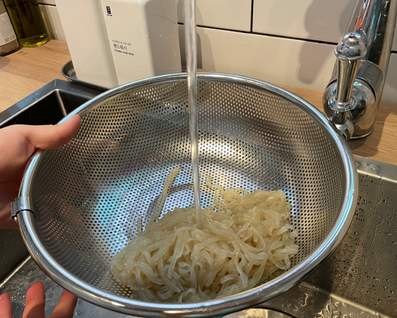 konjac noodles being rinsed in water