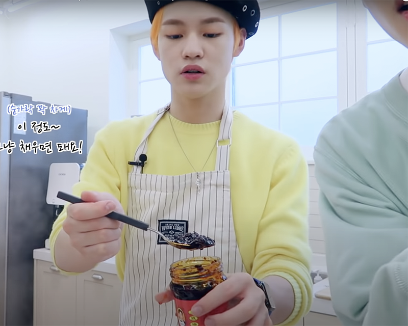 NCT Chenle taking a spoonful of the laoganma sauce