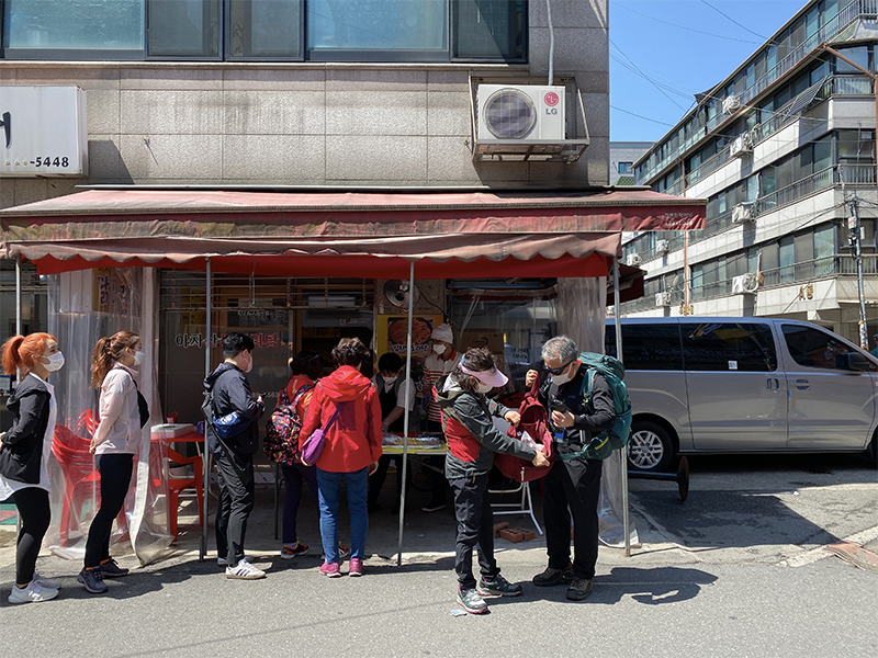People lining up in front of a local eatery in Seoul