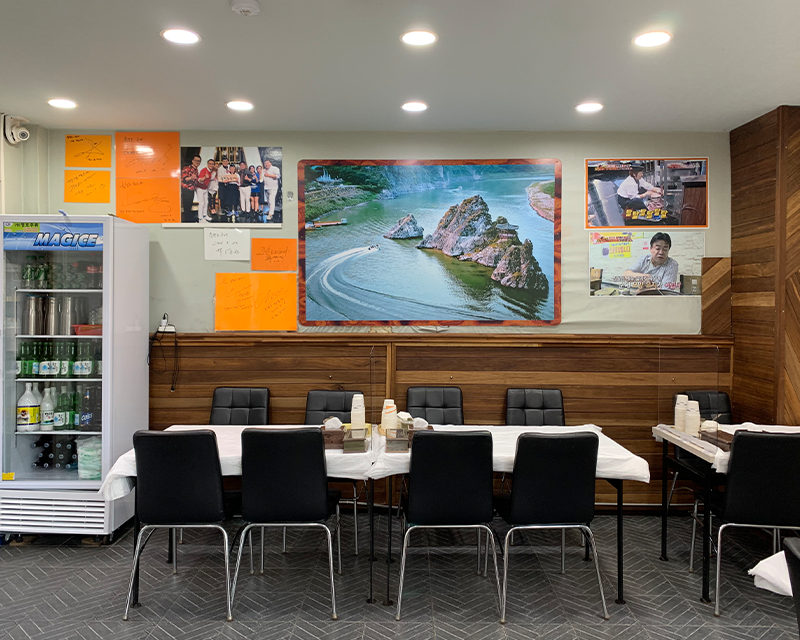 Black chairs and tables inside of Chungcheongdo Sundae