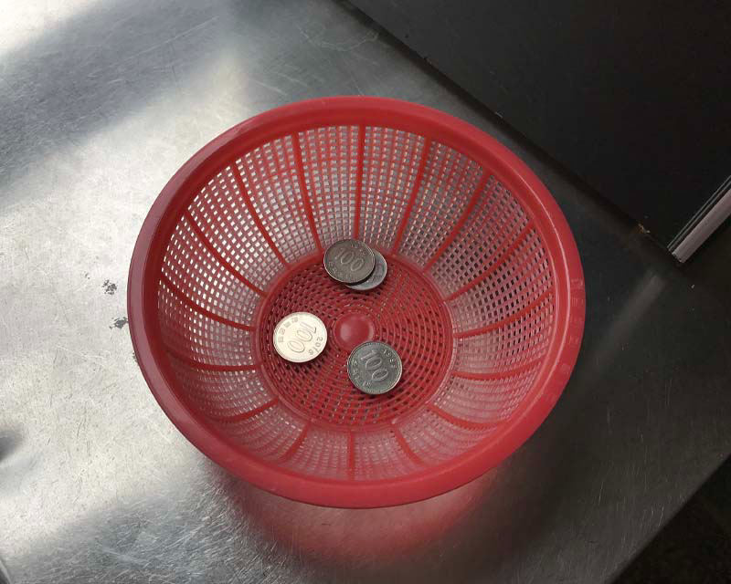 Cafe Yudal Milk coins in a red bucket