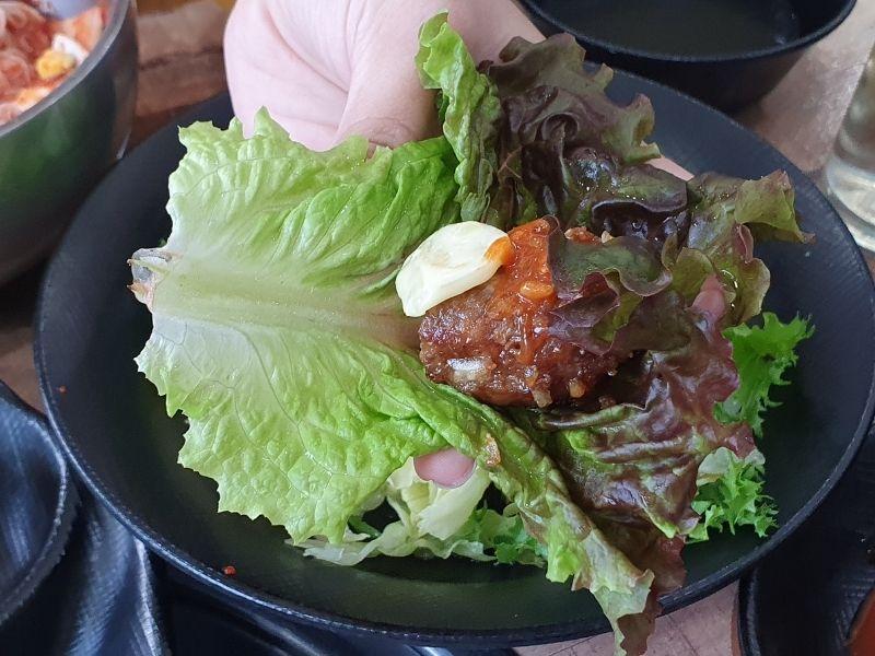 Garlic tteok-galbi wrapped in lettuce at Dawon Restaurant Danyang