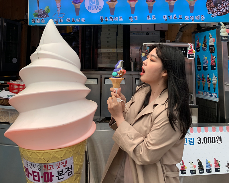 Girl turned to the side eating Atia macaron ice cream at Danyang Gugyeong Traditional Market