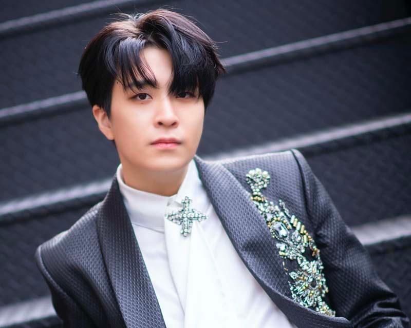 ยองแจในชุดสูทสีเข้มพร้อมการประดับด้วยเพชรบนเสื้อ