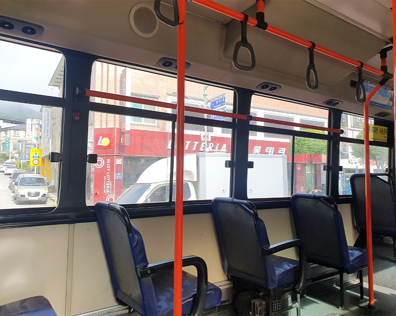 inside seats and red railing of danyang bus