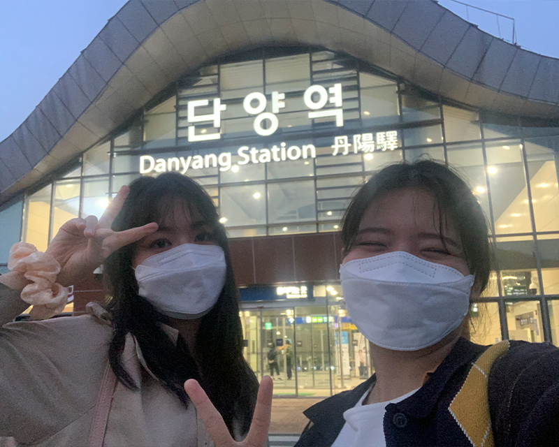 creatrip editors posing at night in front of danyang station in south korea