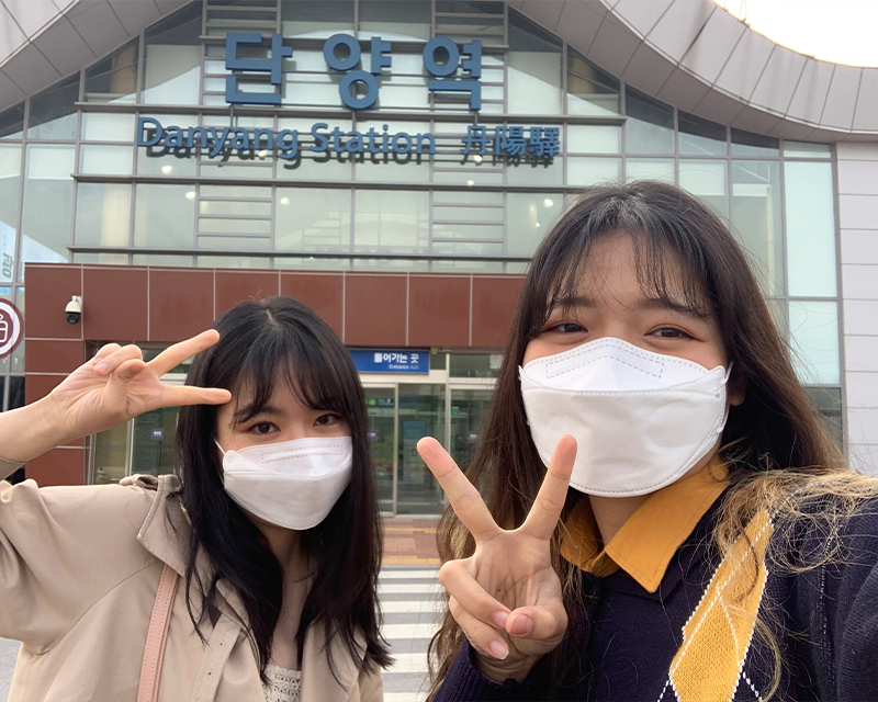 creatrip editors posing in front of danyang station during the day