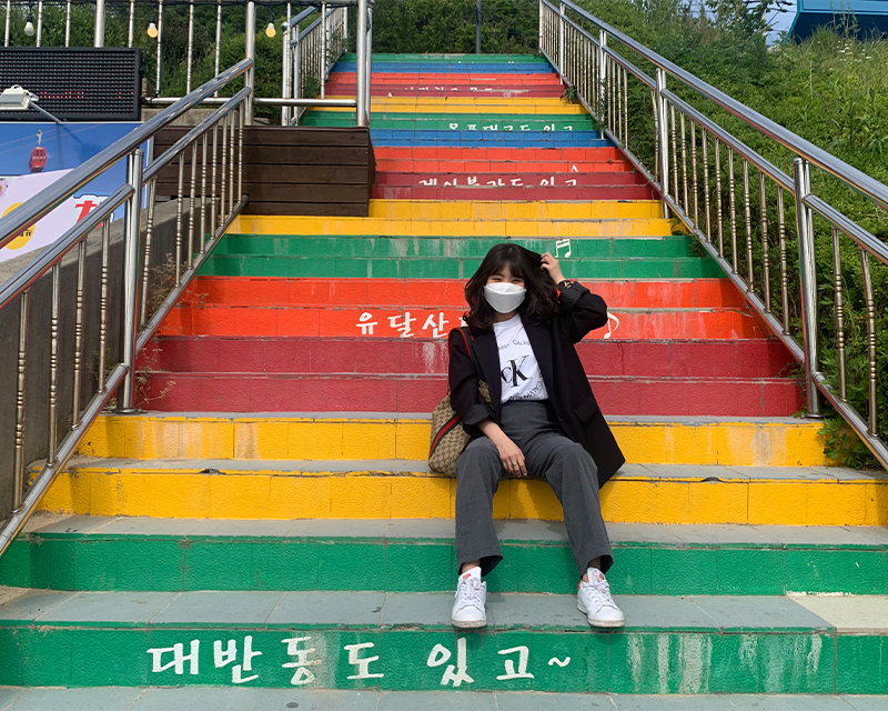 Mokpo Skywalk girl posing on a rainbow staircase