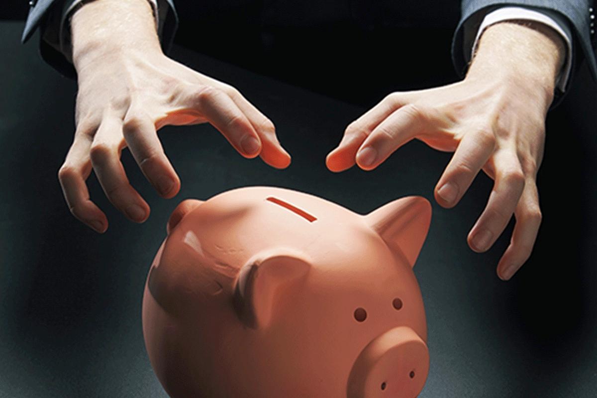 hands reaching for a piggy bank