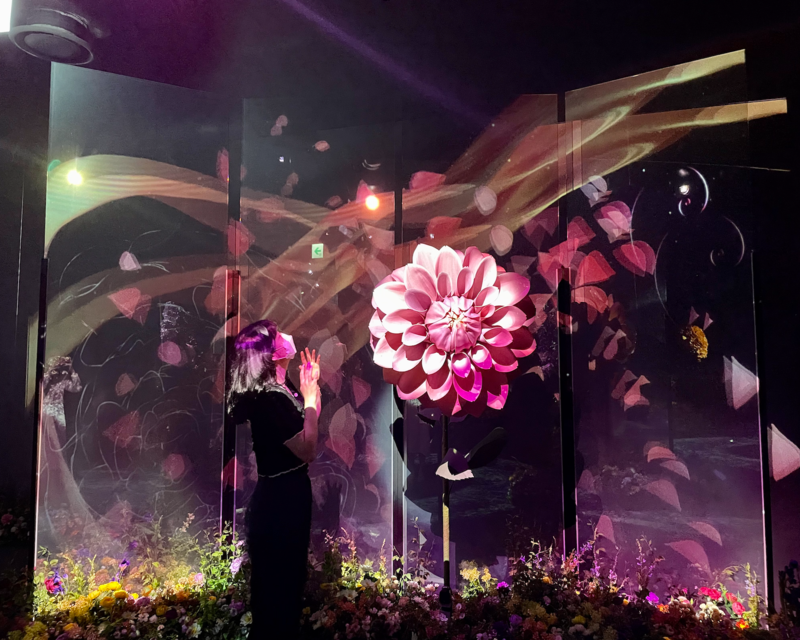 girl standing next to giant pink flower at Flowers By Naked Hongdae