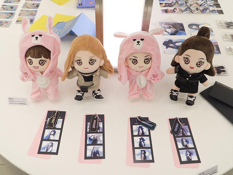 BLACKPINK toy and pictures on a table at YG the SameE cafe