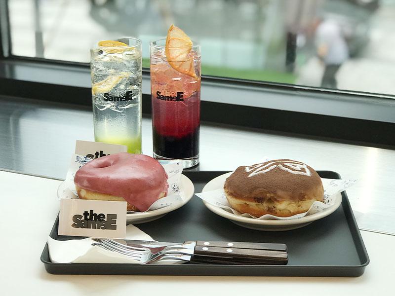 YG the SameE cafe two donuts and drinks on a black tray