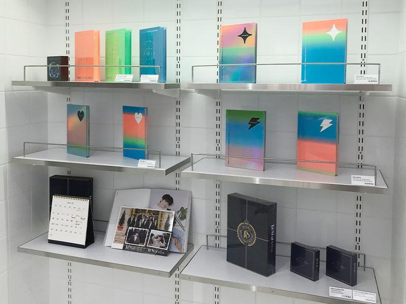 merchandise on display on white shelves at YG the SameE cafe