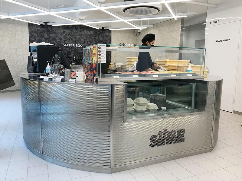 YG the SameE cafe counter with a worker