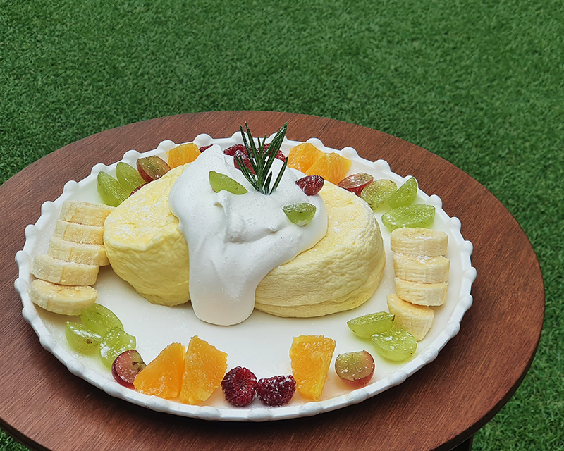 Picnic soufflé served on a white plate on wooden desk at Hongdae Picniq