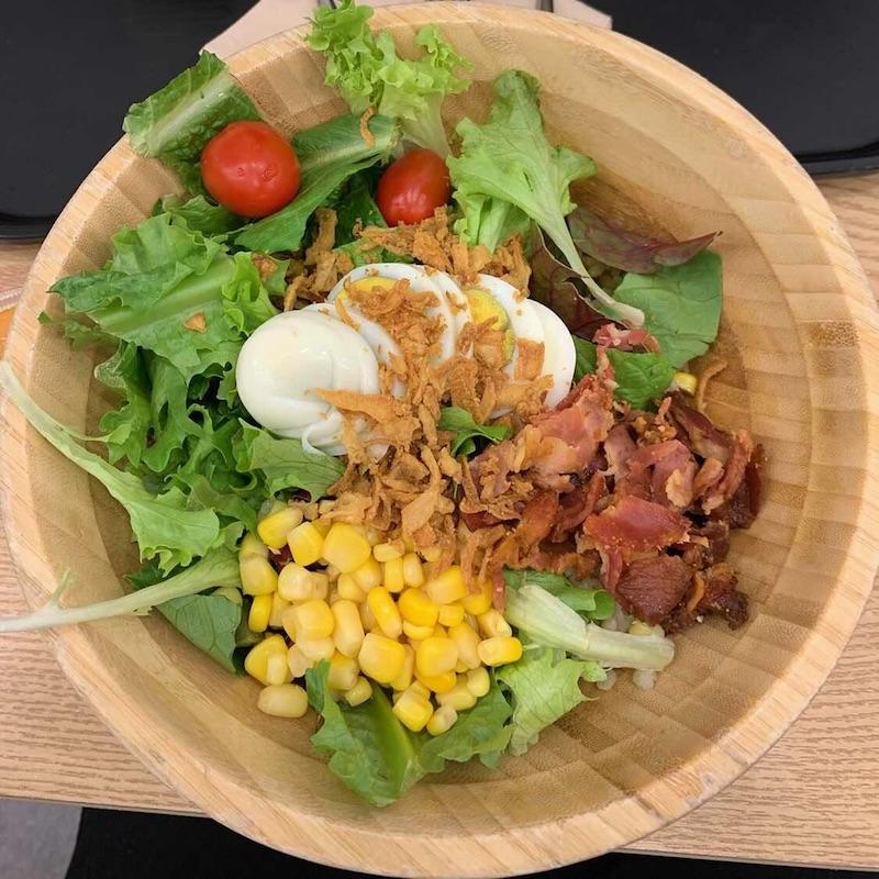 salad with greens, corn, tomato, egg and bacon bits from korean franchise salady