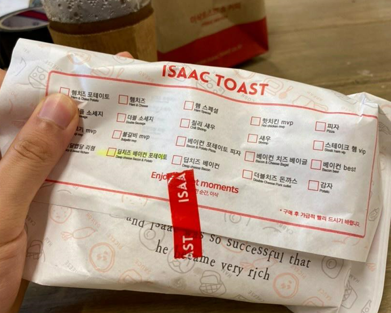 full isaac toast menu on wrapper of sandwiches