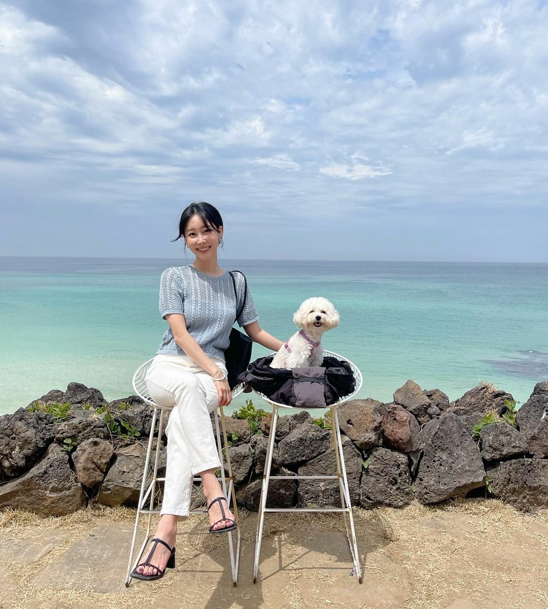 Girl with white dog at Aewol The Sunset Jeju Island